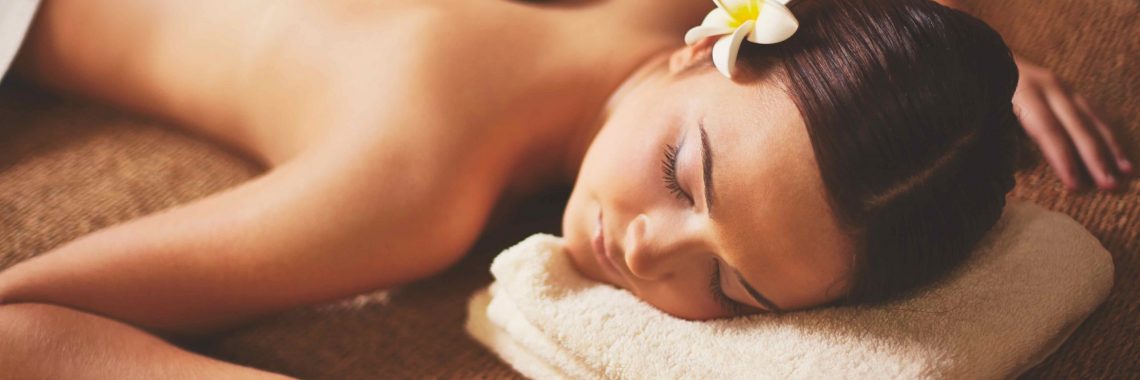 Portrait of young female lying in spa salon during beauty procedure